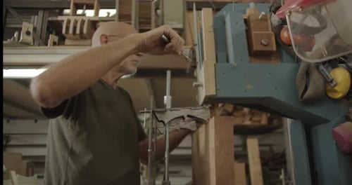 Man Tightens Wood Clamp with Wrench in Shop