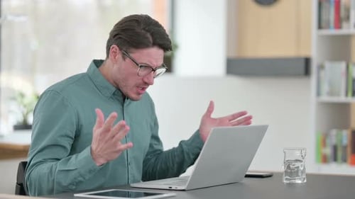 Adult Reacting to Laptop With Shock Indoors