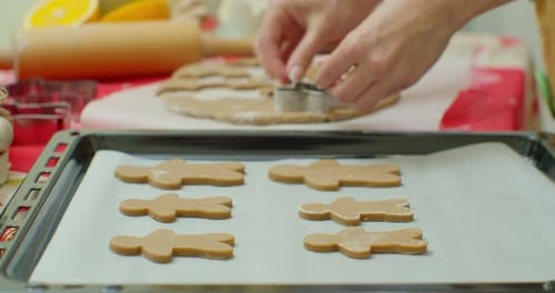 Woman Cuts Gingerbread Cookies for Christmas. Celebration. Making Gingerbread Cookies.