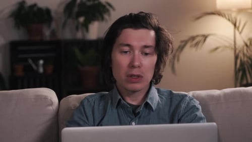 Young Adult on Laptop Having Video Call at Home