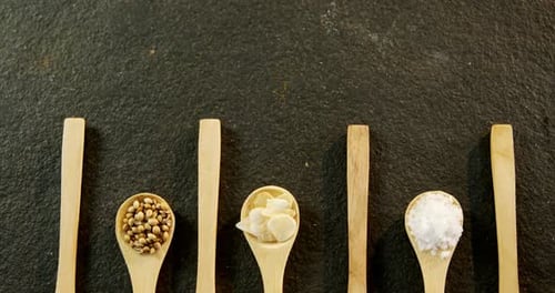 Colorful Spices and Herbs Displayed on Wooden Spoons