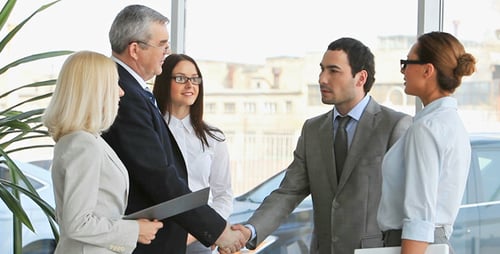 Business Professionals Meeting and Shaking Hands in Office