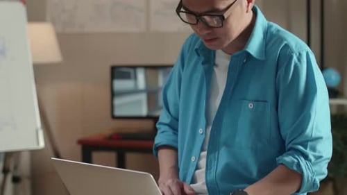 Close Up Of Asian Man Engineer Sitting On The Table And Using A Laptop To Work At The Office