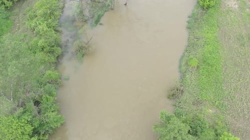 Overflow of river water onto land from above 4K aerial video