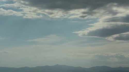View of clouds in sky over distant mountains