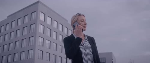 Business Woman Talking on Phone Outside Urban Building