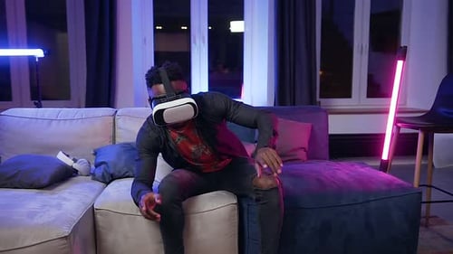 Young Adult Using VR Headset on a Couch