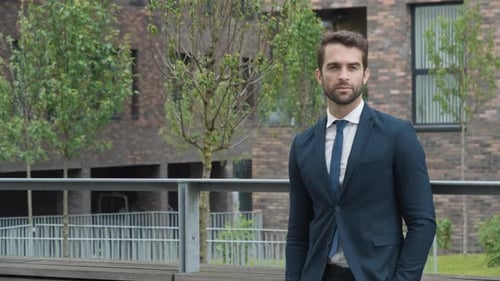 Handsome Businessman Buttoning Jacket