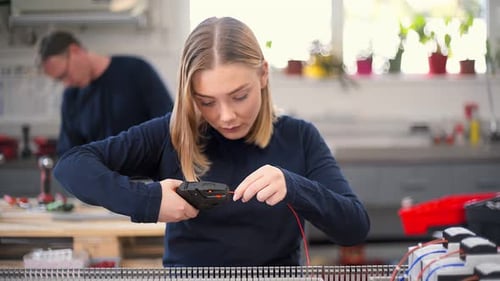 Female electrician working with wire cutter