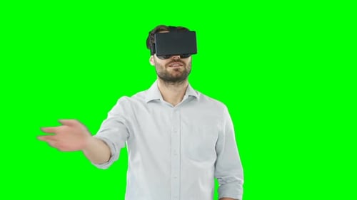 Man Interacting with VR Headset on Green Screen