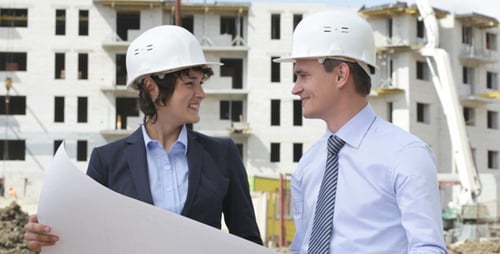 Engineers Reviewing Construction Blueprint on Site