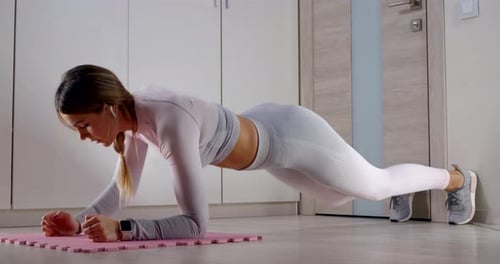 Woman Performs Forearm Plank Exercise at Home