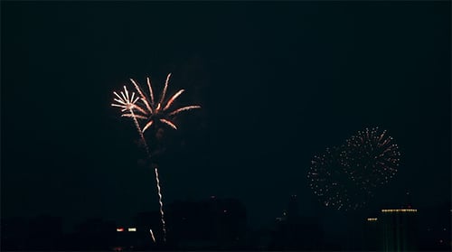 Fireworks Exploding at Night in Urban City