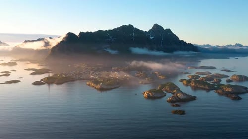 Idyllic Island Village with Mountain Backdrop at Sunrise