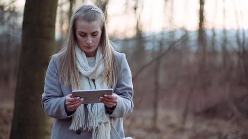Woman Using Digital Tablet in Park