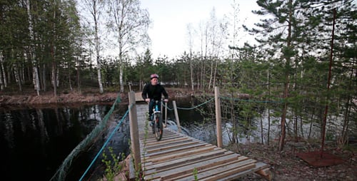 Bicyclist Rides Over The Bridge