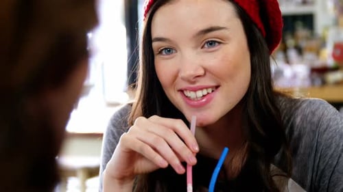 Woman having a drink with a straw