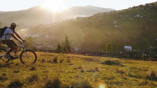 A Man on a Bicycle Stopped To Admire the Mountain Landscape