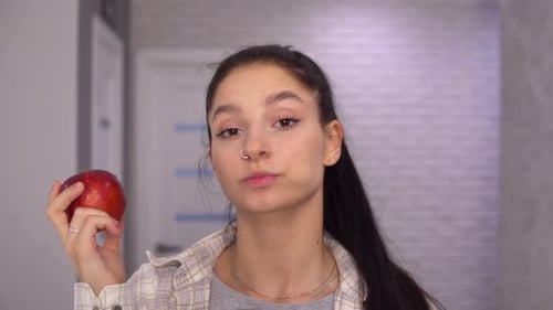 Young Woman Eating a Red Apple Snack