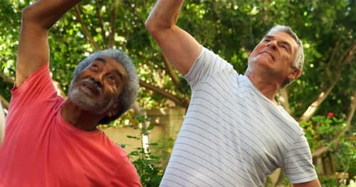 Seniors Exercise Together Outdoors With Helping Friend