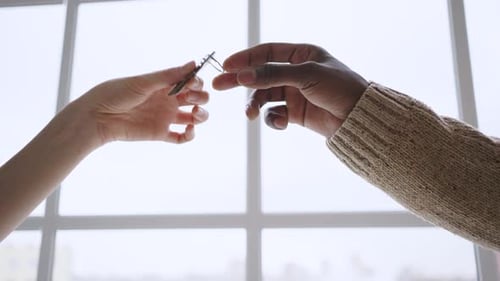 African American Realtor Gives Key From Apartment to Woman
