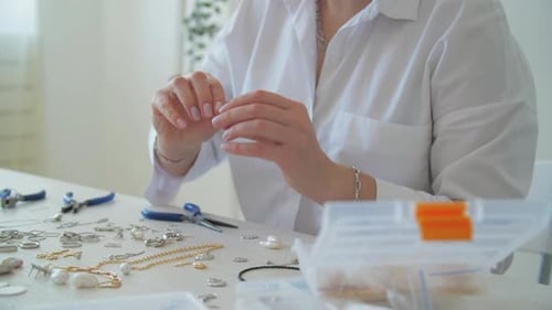 Woman Making Jewelry at Home at Table