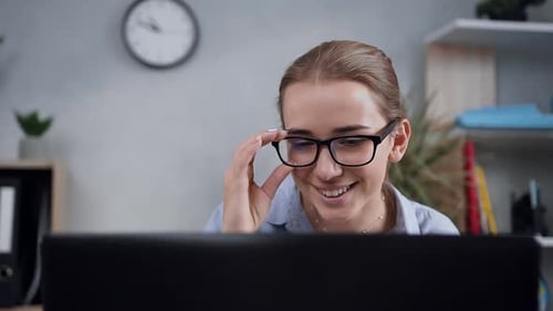 Young Woman Works at Laptop in Bright Office