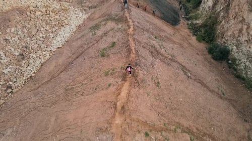 Aerial view on hickers crossing top of the hill