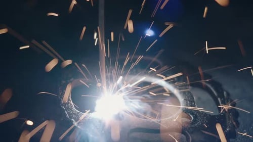 Glowing Welding Torch Sparks in Dark