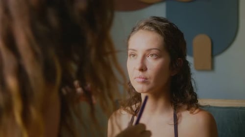 Woman Having Eye Makeup Applied by Friend