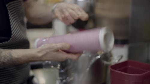 Close View of Unrecognizable Male Chef Wrapping Plastic Around Pot