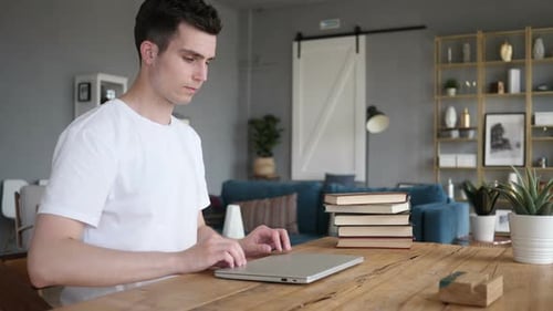 Man Leaving Desk after Completing Work on Laptop