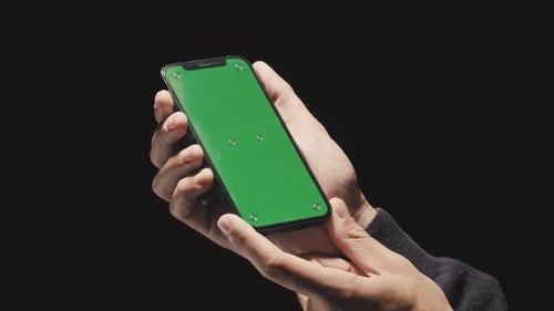 Closeup Male Hands Holding Smart Phone with Green Screen