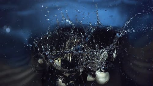 White Mushrooms Falling into Water Creates Splash