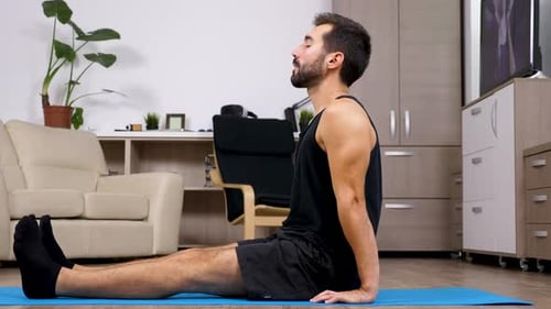 Man on Yoga Mat Doing Yoga Pose Indoors
