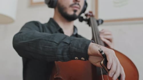 Musician Playing Cello With Bow Indoors