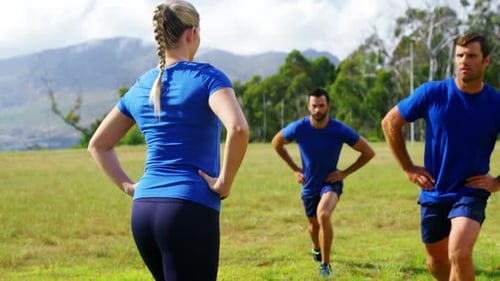 Female trainer training people in boot camp