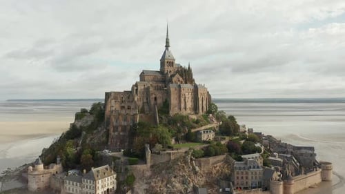 Wide View of Le Mont Saint Michel Castle in the Ocean in France, Aerial, Cloudy
