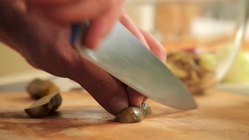 Slicing Pickles on a Cutting Board Close Up