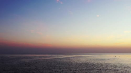 Wide angle aerial clean view of a white sandy paradise beach and aqua blue ocean background