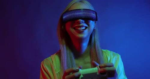 Young Asian woman playing metaverse virtual reality digital technology game with VR goggle.