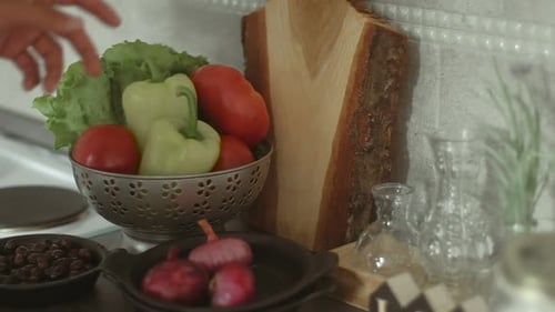 Male hands with cutting board. Man is cooking fish with baked vegetables. Slow motion