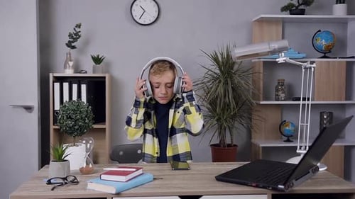 Child Listens to Music and Dances Indoors