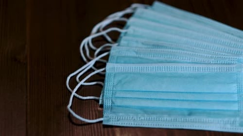 Light Blue Disposable Face Masks on Wooden Surface