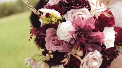 Close Up of Bride in Her Wedding Gown Outdoors Holding Bouquet of Pink, Purple, and White Flowers 10