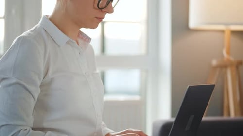 Woman Works at Laptop in Bright Home Office