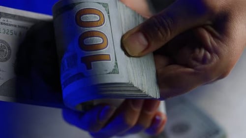 Hands Counting Stack of One Hundred Dollar Bills