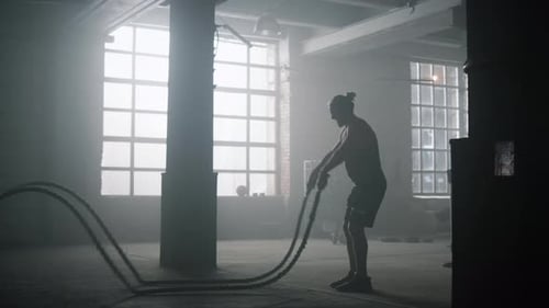 Muscular Man Working Out With Battle Ropes