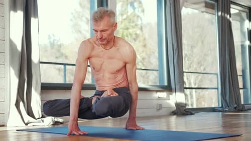 Muscular Adult Balances in Yoga Pose