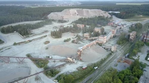 Abandoned Mining Factory with Railway Against Grey Barrow